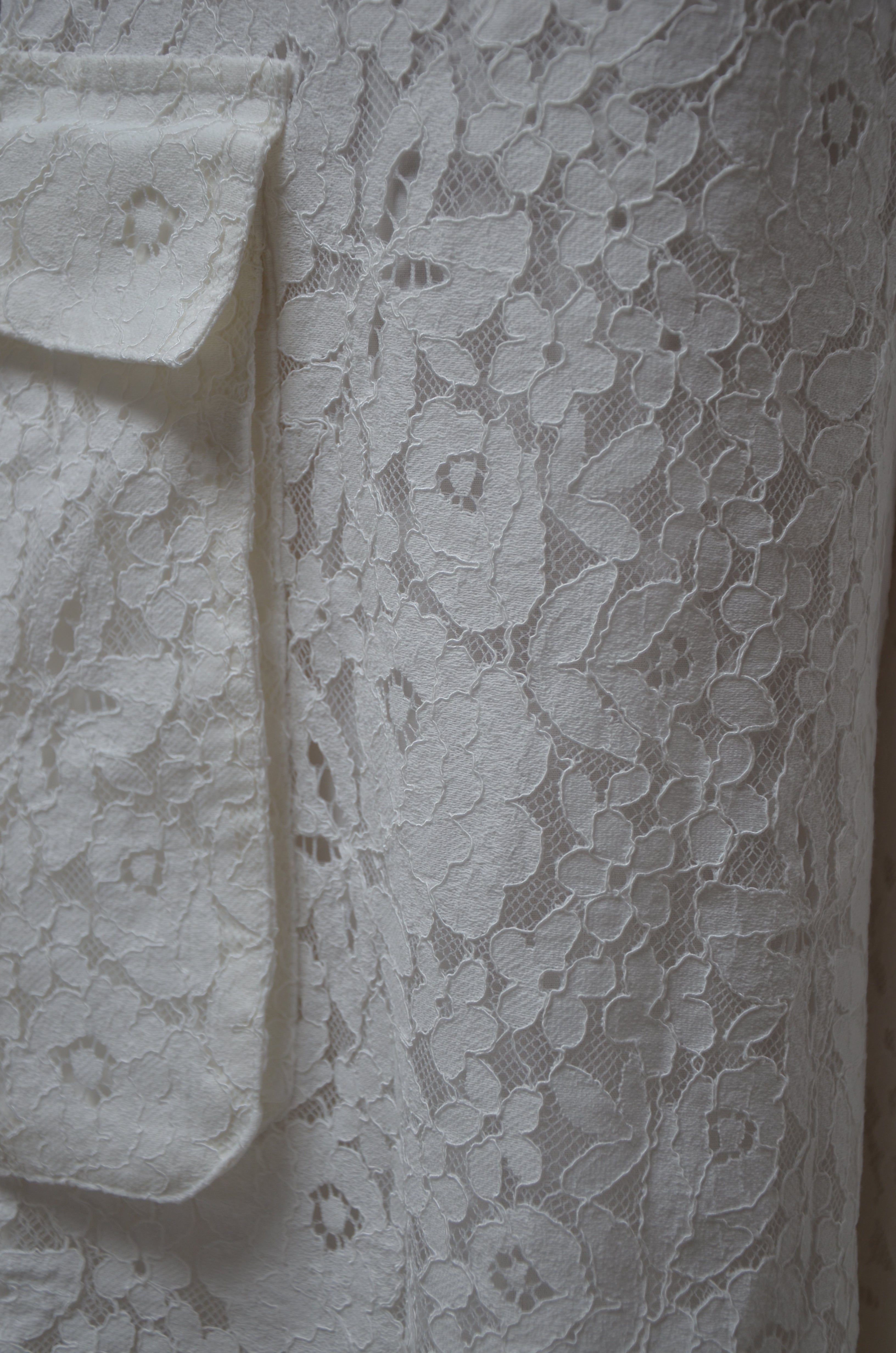 Close-up of white lace fabric with intricate patterns